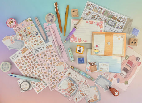 assortment-of-stationery-pens-notebooks-inks-and-other-products-placed-on-a-desk